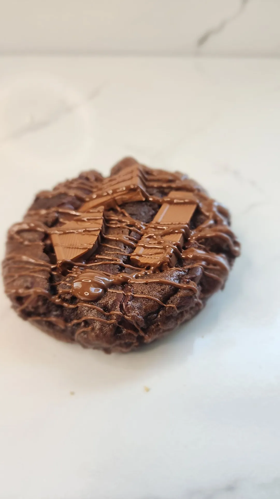 The Velvet Whisk triple chocolate cookie with chocolate pieces and drizzle