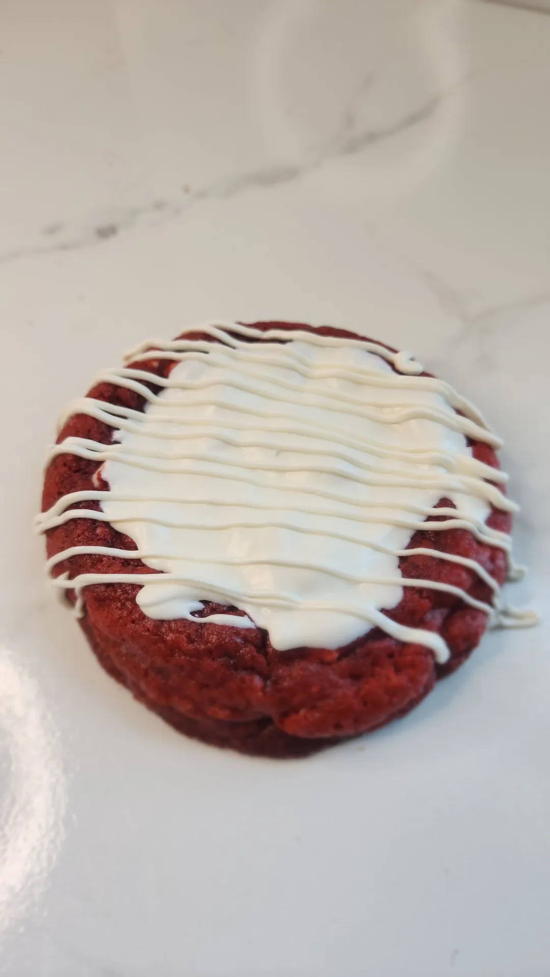 The Velvet Whisk red velvet cookie with white drizzle