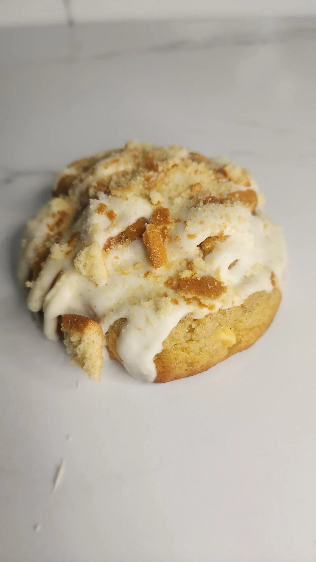The Velvet Whisk banana pudding cookie topped with cookie pieces and cream
